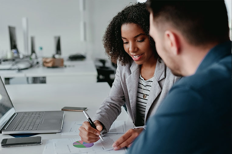 Woman reviewing financial strategy with man