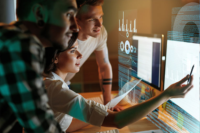 Woman showing two men cloud operations at large screen