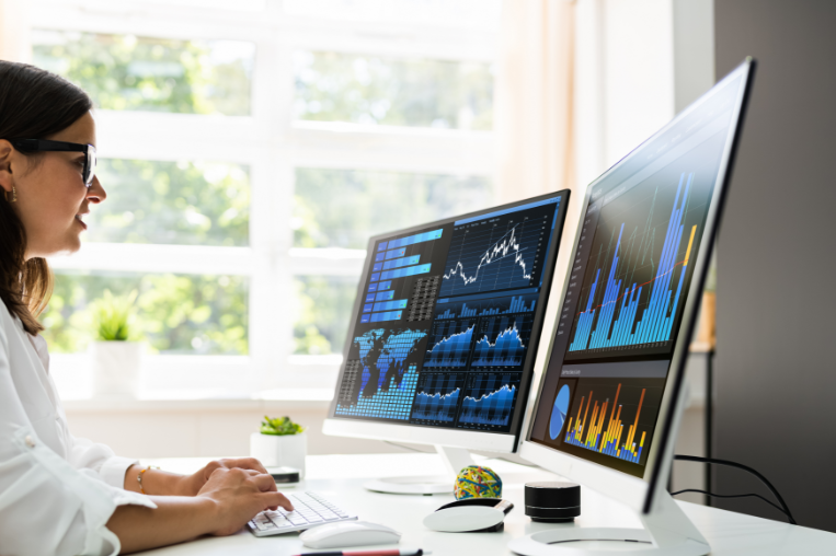 Woman reviewing dashboards on desktop screen